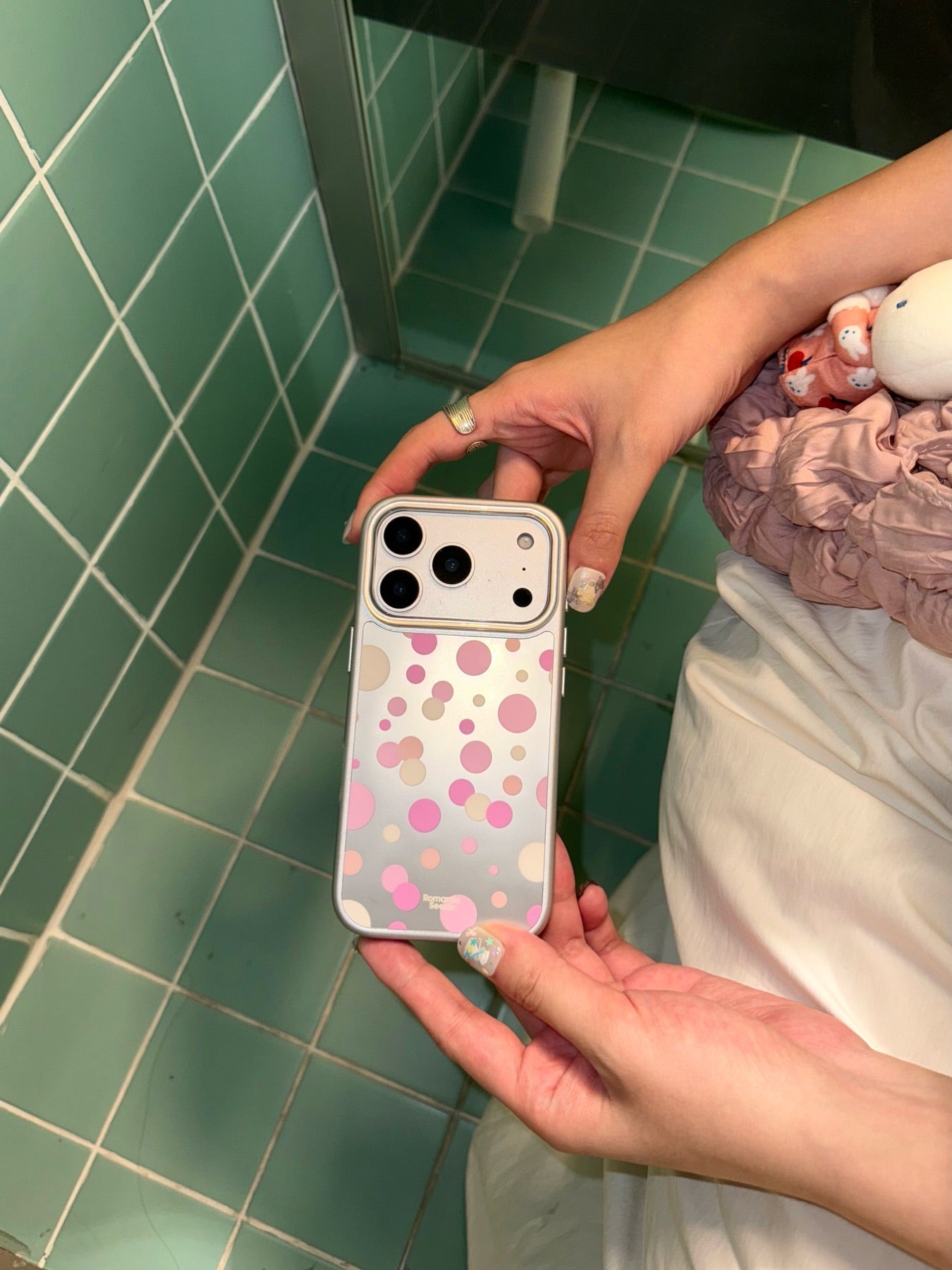 Bubble Pop phone case styled in a green tiled room